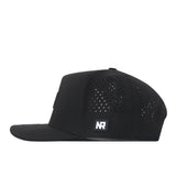 The Colorado Buffaloes Trainer Hat by No Rivals is a black flat-bill snapback with a structured fit, small ventilation holes on the sides, and an NR logo patch on the lower side panel. Made from cotton, the hat is displayed in a side profile view.