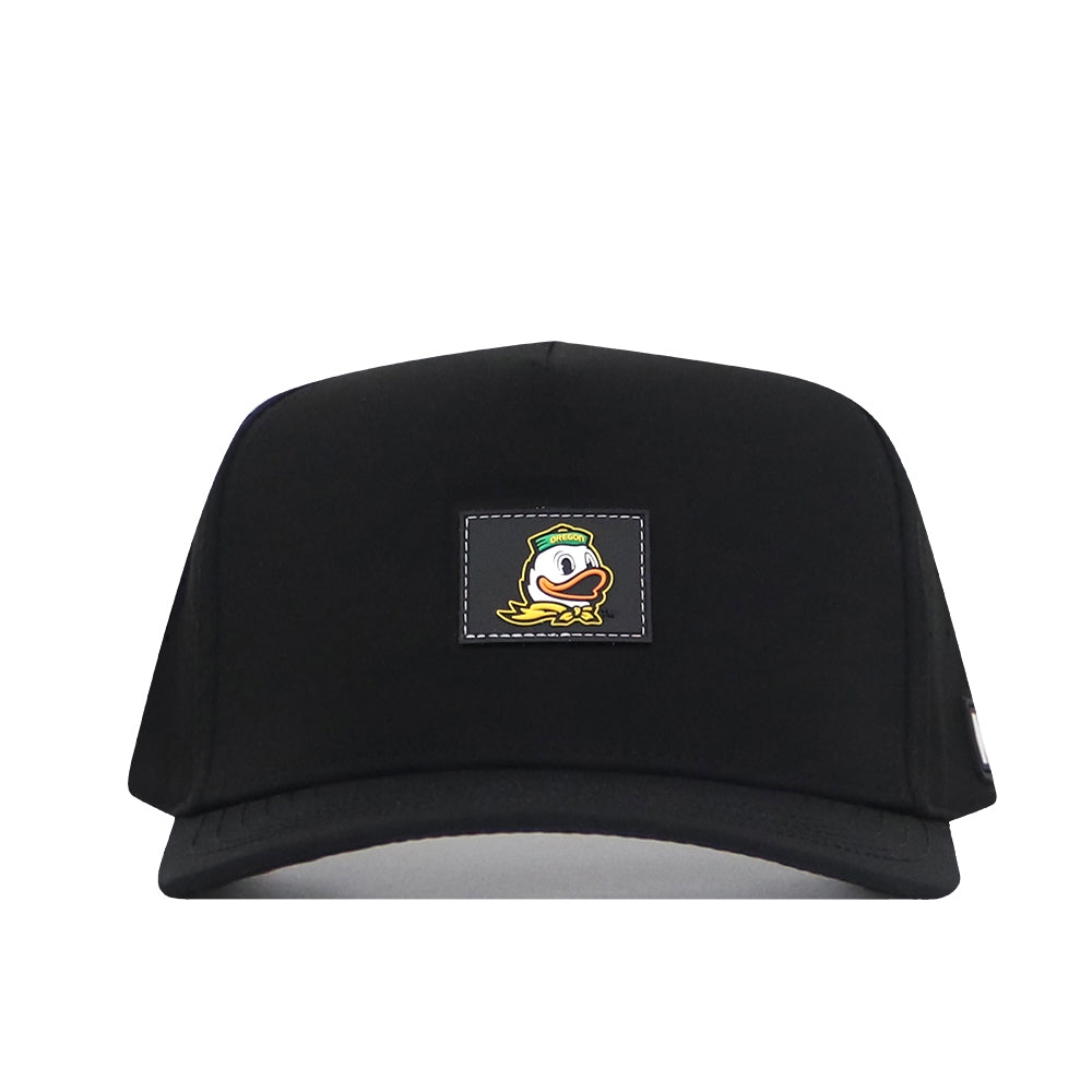 The Oregon Ducks Trainer Hat by No Rivals is a black snapback cap made from high-quality cotton for lasting comfort and durability. It features a structured fit and showcases a rectangular patch with a cartoon duck logo on the front center, making it a stylish and practical choice for everyday wear.