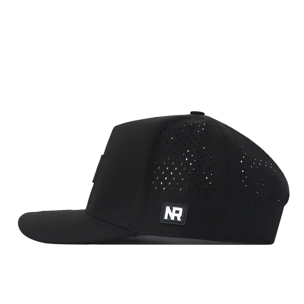 A side view of the Oregon Ducks Trainer Hat by No Rivals, a black snapback crafted from high-quality cotton with small ventilation holes and a rectangular NR logo patch on the side. This cap features a flat brim and a structured fit for a sleek, modern look.
