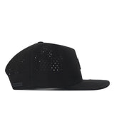 The Oregon Ducks Trainer Hat by No Rivals is displayed from the side against a white background. This black snap back hat features a structured fit, flat brim, and ventilation holes. Crafted from high-quality cotton, it combines style with comfort.