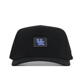 Introducing the Kentucky Wildcats Trainer Hat by No Rivals—a high-quality cotton black baseball cap featuring a prominent blue and white UK logo patch on the front center. This structured fit cap includes a classic snapback closure, all showcased against a plain white background.