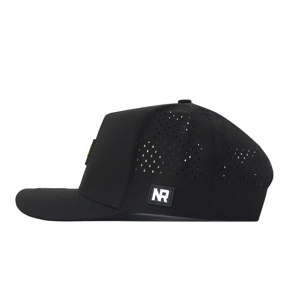 A side-view of the North Dakota State Bison Trainer Hat by No Rivals in black, showcasing small ventilation holes on the back and a square NR logo patch above the snapback adjustment for a perfect gameday fit.