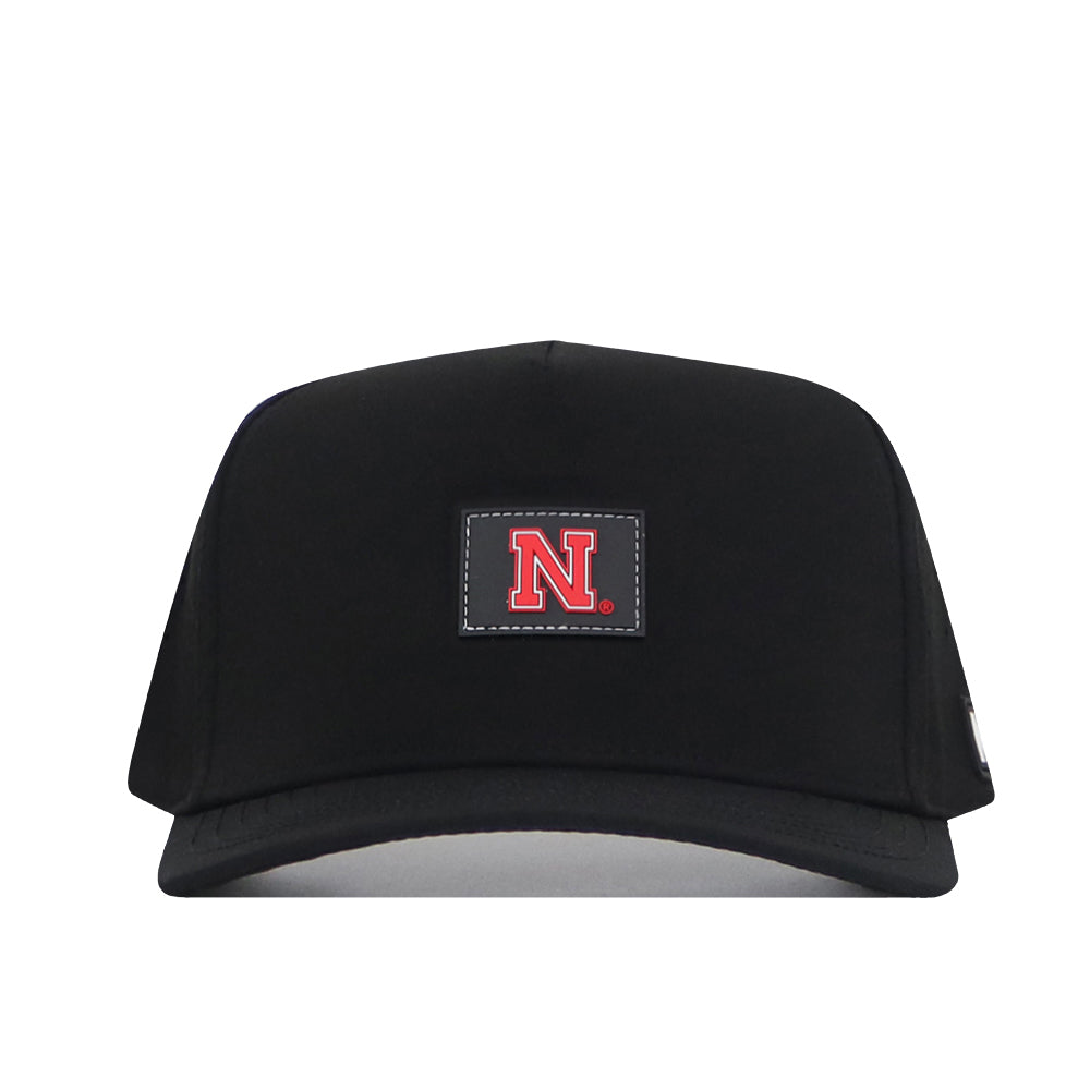 Complete your gameday look with the Nebraska Cornhuskers Trainer Hat by No Rivals—a black snapback featuring a rectangular front patch with a bold red ‘N’ outlined in white.