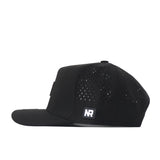 Side view of the Nebraska Cornhuskers Trainer Hat by No Rivals, featuring small ventilation perforations and a rectangular NR patch near the back. This snapback blends comfort and style with premium details—an ideal addition to your game day look.