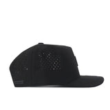 A black Nebraska Cornhuskers Trainer Hat by No Rivals with a flat brim, shown in profile. The side panels feature small perforations for ventilation, making it the perfect officially licensed gameday fit.