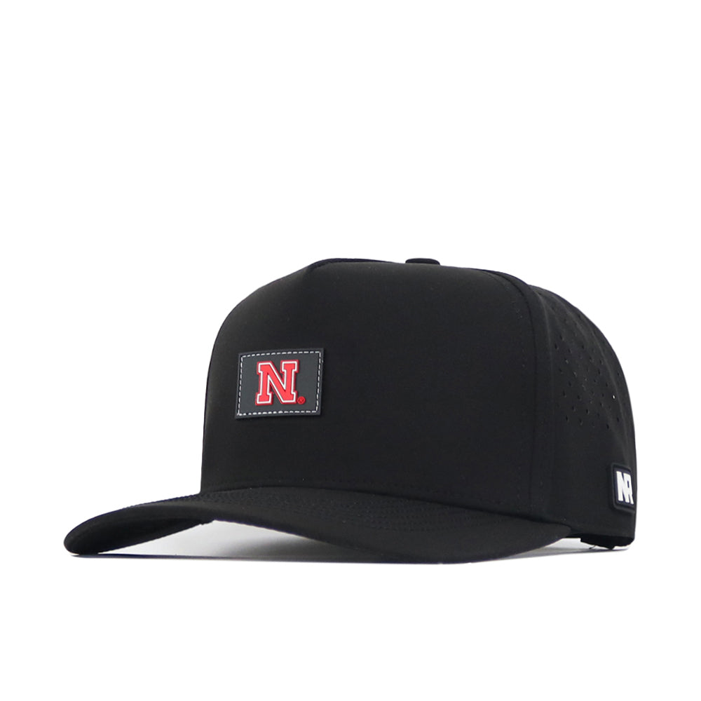 The Nebraska Cornhuskers Trainer Hat by No Rivals is a black snapback cap featuring a bold red N rubberized logo on the front and a small NR tag on the side, shown against a white background—perfect for your gameday fit.