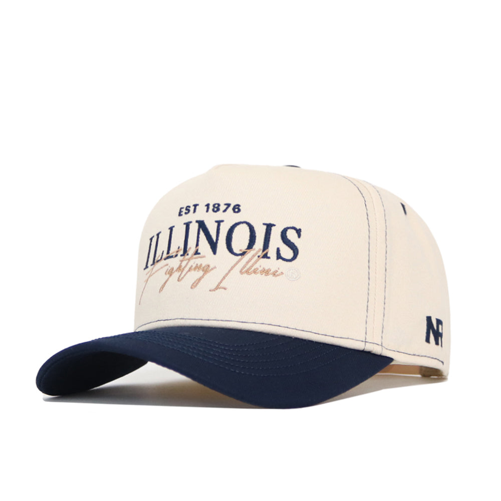 The No Rivals University of Illinois Vintage Hat is a beige and navy structured cap made from premium cotton, featuring "EST 1876 ILLINOIS Fighting Illini" embroidery on the front and "NF" stitched on the side.