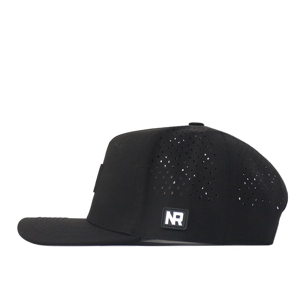 The WVU Mountaineers Trainer Hat by No Rivals is a black snapback cap with a structured fit, featuring small ventilation holes on the side and a rectangular No Rivals logo patch. The hat is photographed from the side against a white background.