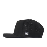 The WVU Mountaineers Trainer Hat by No Rivals is a black snapback cap with a structured fit, featuring small ventilation holes on the side and a rectangular No Rivals logo patch. The hat is photographed from the side against a white background.