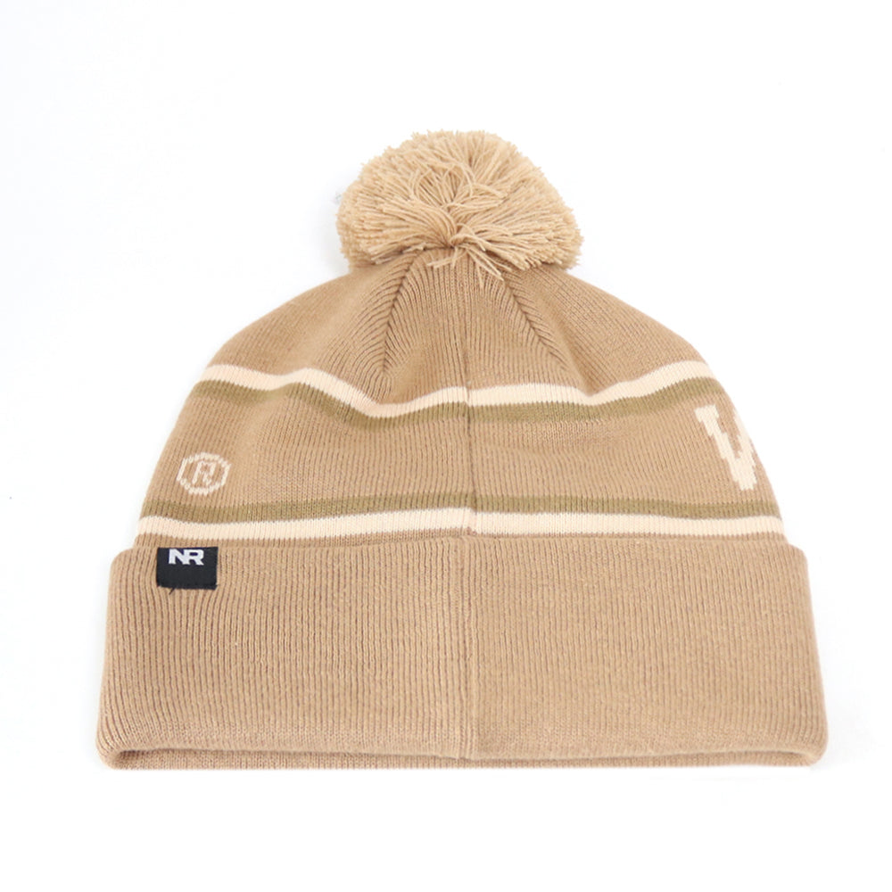 Show your Badger pride with the Wisconsin Badger Desert Beanie from No Rivals. This tan knit beanie features a playful pom-pom on top, two slim horizontal stripes, and a small embroidered logo on the front—ideal for gameday style. A black tag with “NR” accents the folded brim for an extra touch of brand detail.
