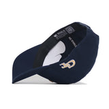 A navy Georgia Tech Block T Hat by No Rivals is shown on its side, revealing the inside. It features an embroidered gold and white GT logo on the front and “NO RIVALS” printed on the inner headband.