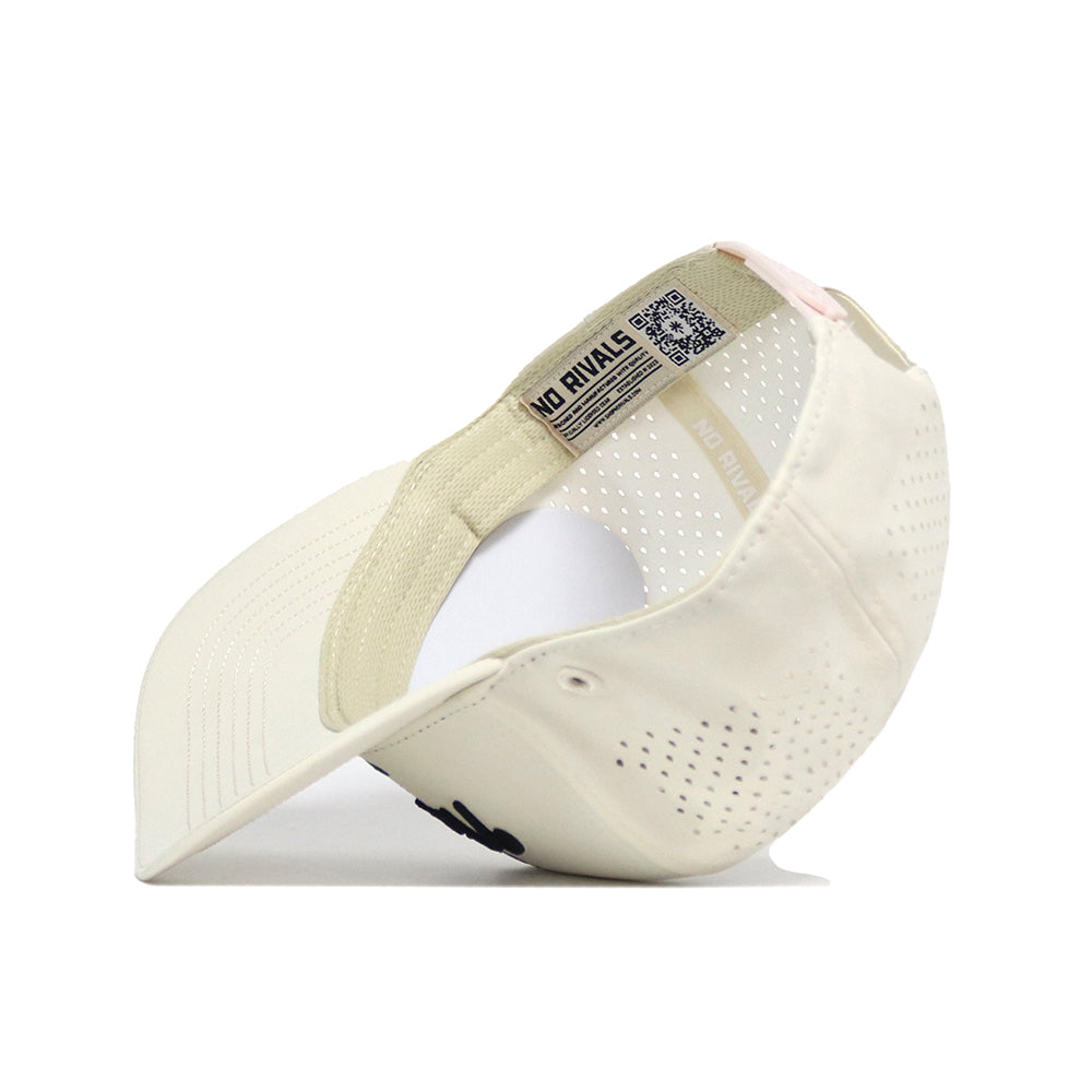 The No Rivals Golf Hat in tan is shown upside down, highlighting its perforated sides, curved brim, inner sweatband, NO RIVALS label, and a pink snapback strap—ideal for your gameday look.