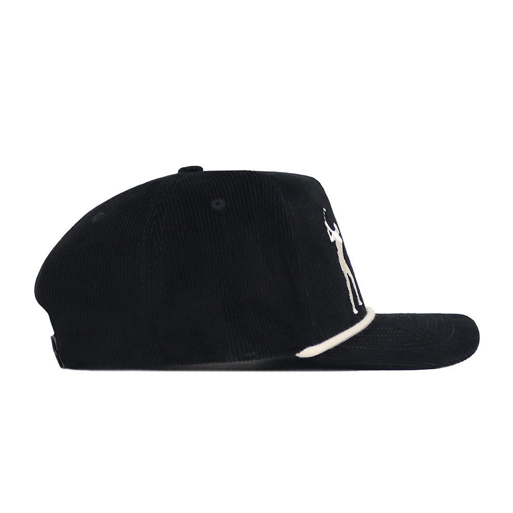 The No Rivals Sunday Round Cord Hat - Black features black cotton corduroy, front embroidered logos, a white accent above the brim, and a snap back closure for adjustable fit, shown in profile view.