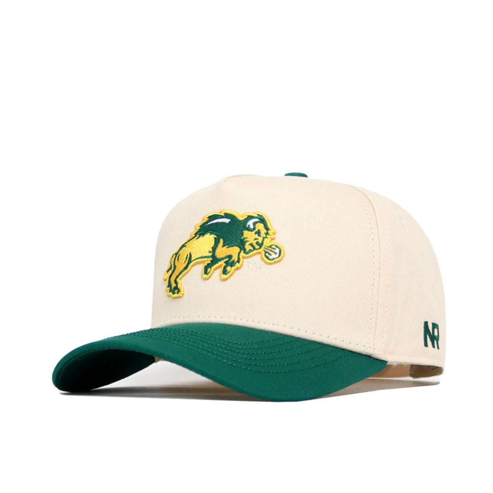 The No Rivals NDSU Logo Patch Hat is a cream snapback with a green bill, embroidered yellow and green bison logo on the front, NR stitched on the side, and made from high-quality cotton.