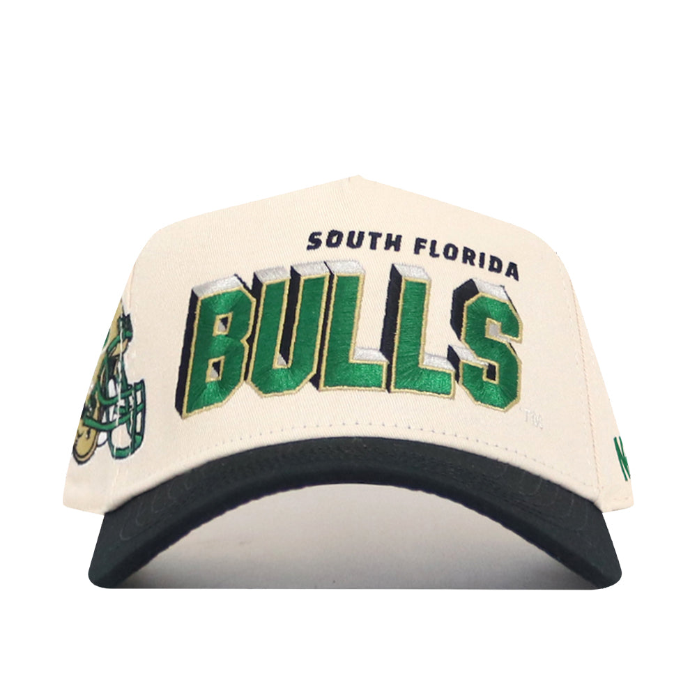 A cream and black snapback from the USF Alma Mater Collection by No Rivals, featuring "South Florida Bulls" embroidered in green, black, and gold and a bull mascot detail. Made from high-quality cotton and officially licensed for true fans.