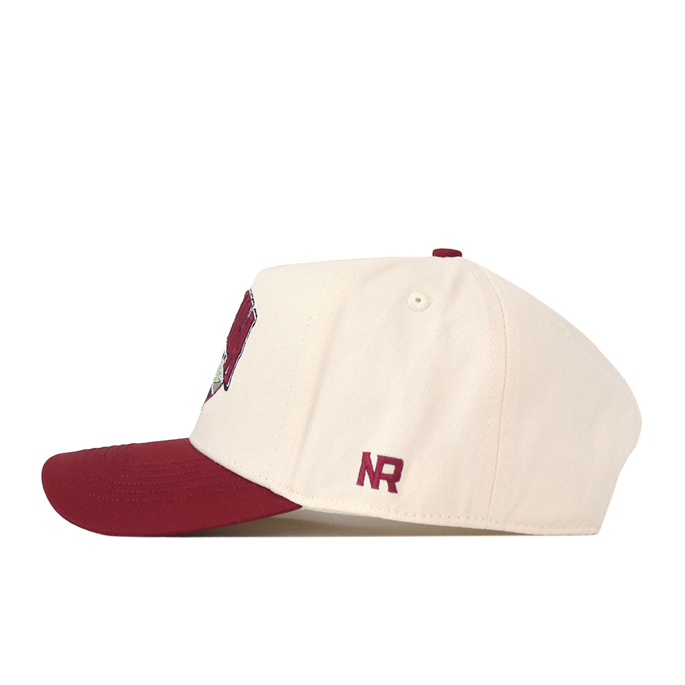 The No Rivals Montana Grizzlies Stadium Hat is a cream-colored baseball cap featuring a maroon brim and embroidered NR initials on the left side. This officially licensed cap showcases high-quality embroidered logos and offers a convenient snapback closure for an adjustable fit.