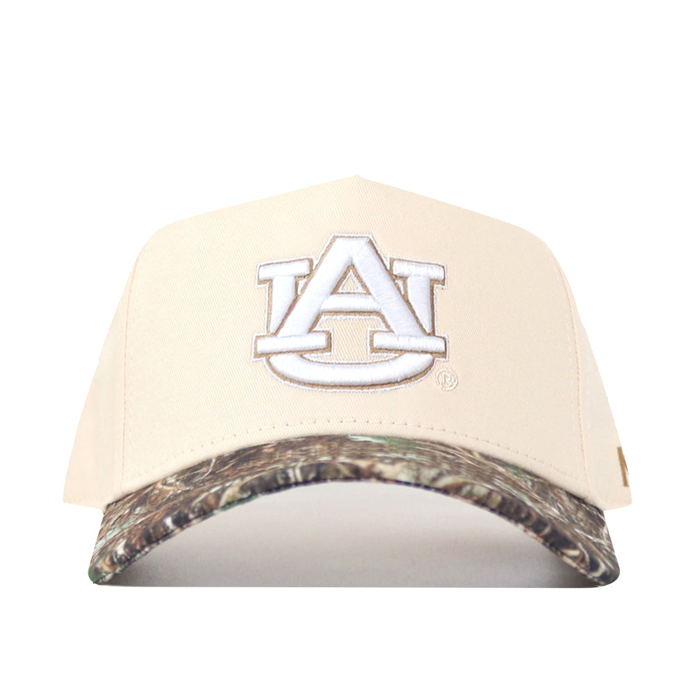 The No Rivals Auburn Camo Connector Hat pairs a beige snapback design with a white embroidered AU logo on the front and a camouflage-patterned brim—making it the perfect finishing touch for your gameday fit.
