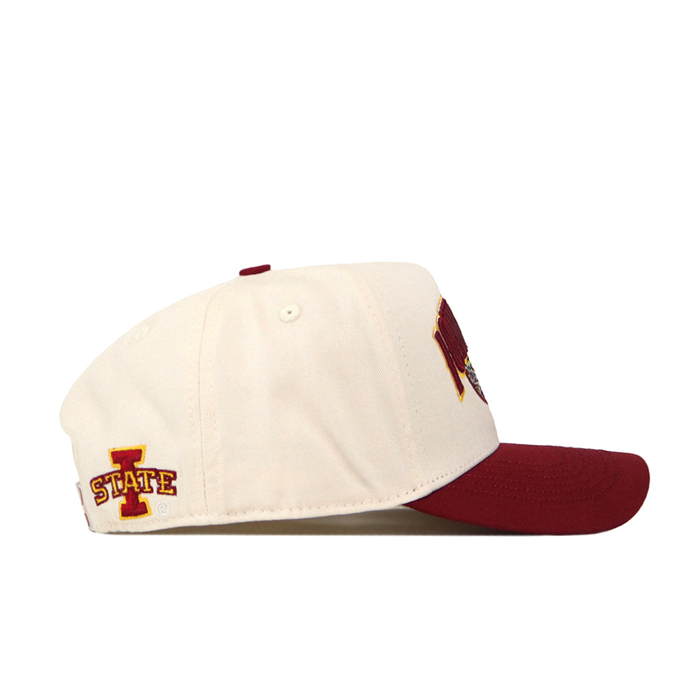 Introducing the Iowa State Stadium Hat by No Rivals—a cream baseball cap made from premium cotton, featuring a striking red brim. The left side displays the iconic Iowa State I State logo in red and yellow with detailed embroidered graphics, while the front showcases a bold red and yellow design that is partially visible from the side angle.