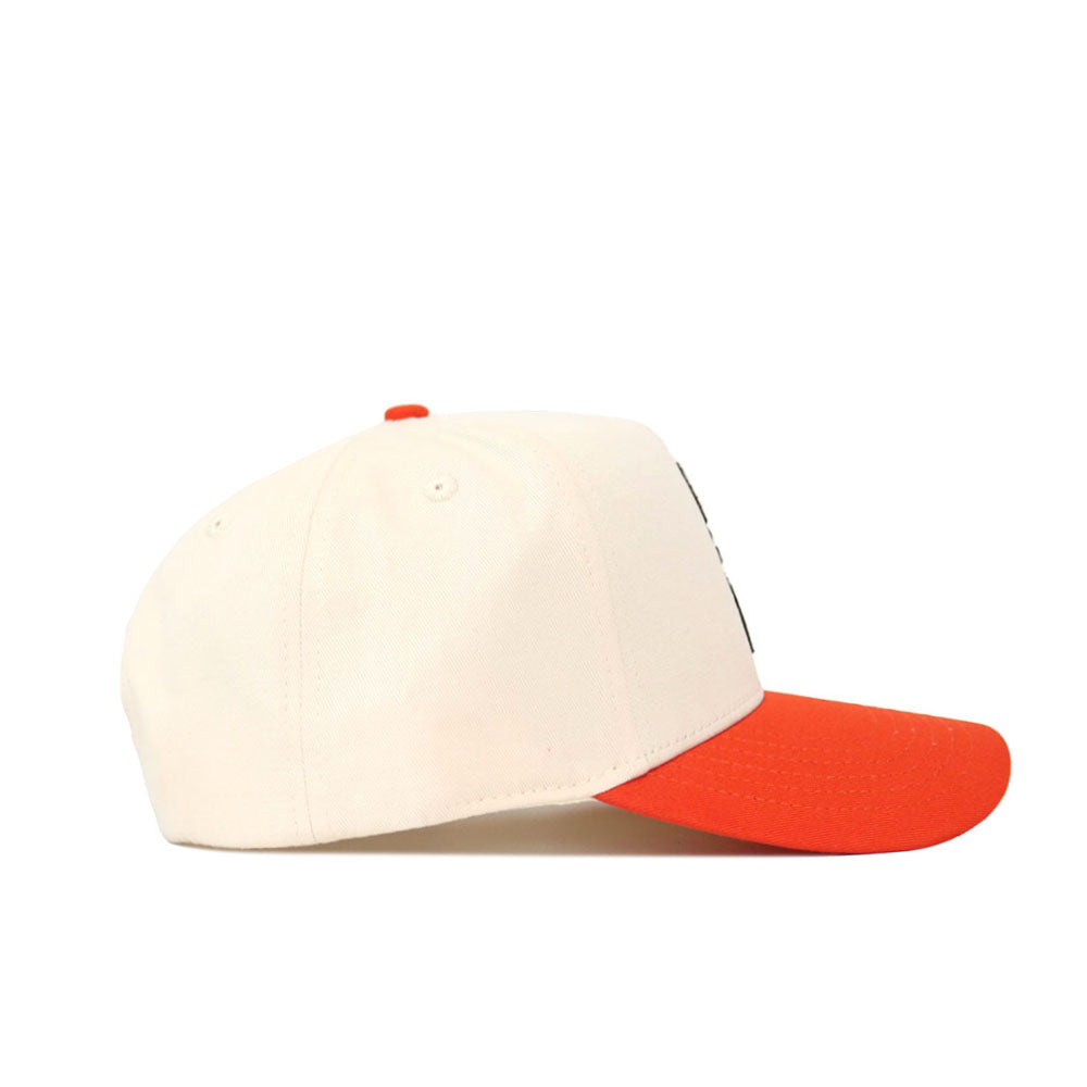 The No Rivals OSU Full Pistol Pete Patch Hat, a cream cotton cap with an orange brim and structured fit, is shown from the side against a white background.
