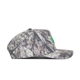A side view of the No Rivals North Dakota Outland Hat, a camouflage snapback with a small green embroidered front logo, made from high quality cotton and designed for a structured fit.
