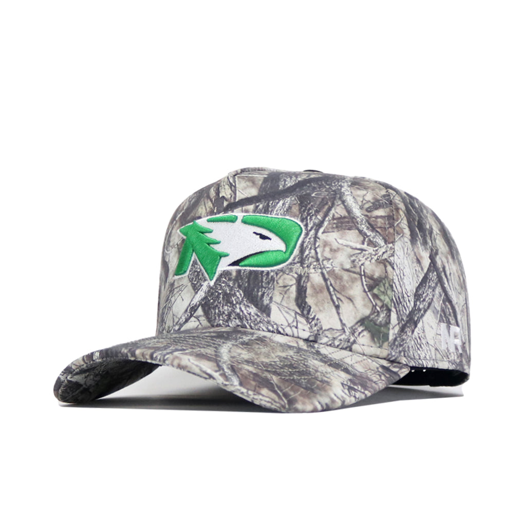 The North Dakota Outland Hat by No Rivals is a structured, high-quality cotton baseball cap with a camouflage pattern and a green and white bird head logo on the front, shown against a plain white background.