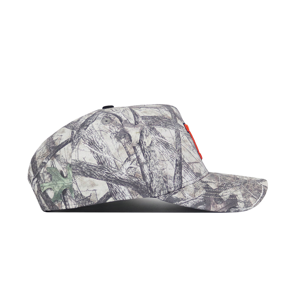 The Illinois Outland Hat by No Rivals is a gray camouflage snapback with a structured fit and flat brim, featuring a tree branch and leaf pattern. Made of high-quality cotton, the cap is shown from a side profile view.