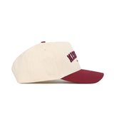 The No Rivals Missoula Hometown Hat features a cream structured fit, burgundy brim, embroidered front text, and premium cotton construction, shown in a side view on a white background.