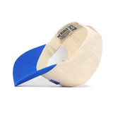 The No Rivals Provo Hometown Hat lies on its side, revealing the cotton cream crown and blue brim. A label with text and a QR code is stitched to the inner band of this structured fit cap.