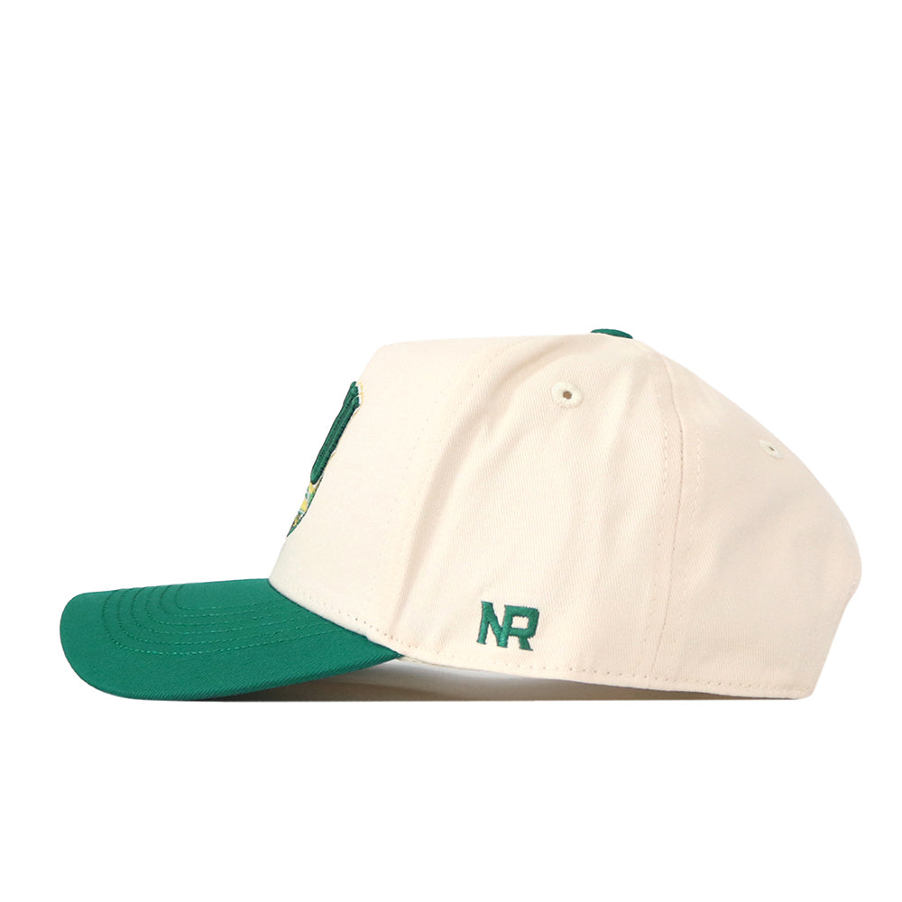 A side view of the North Dakota State Bison Stadium Hat by No Rivals, featuring a cream-colored crown and a green bill. Green embroidered “NR” lettering is stitched near the back.