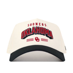 The Oklahoma Letterman Hat by No Rivals is a white cotton snapback featuring SOONERS OKLAHOMA and the OU logo in red and black embroidery on the front, plus an official license and a stylish black curved brim.