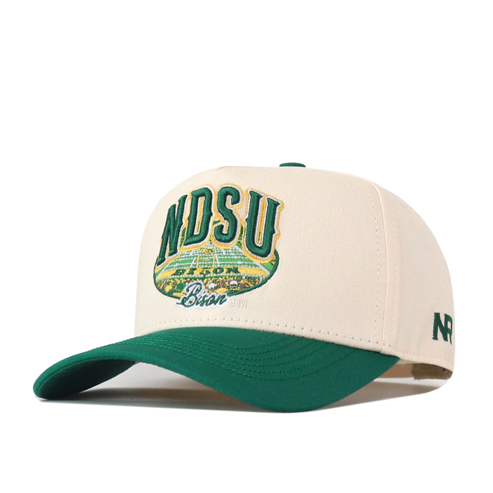 The North Dakota State Bison Stadium Hat by No Rivals is an officially licensed white and green snapback, featuring NDSU and Bison embroidered on the front with a stadium design. Additional details include embroidered logos and green NR lettering stitched on the right side.