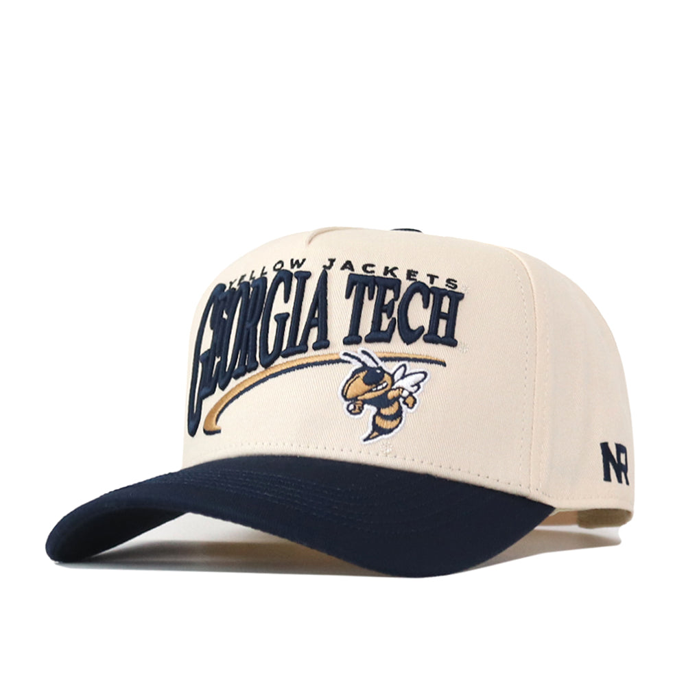 The No Rivals Georgia Tech STRIDE Hat is a beige and navy snapback featuring standout embroidered Georgia Tech lettering and the Yellow Jacket mascot on the front—perfect for taking your gameday fit to the next level.
