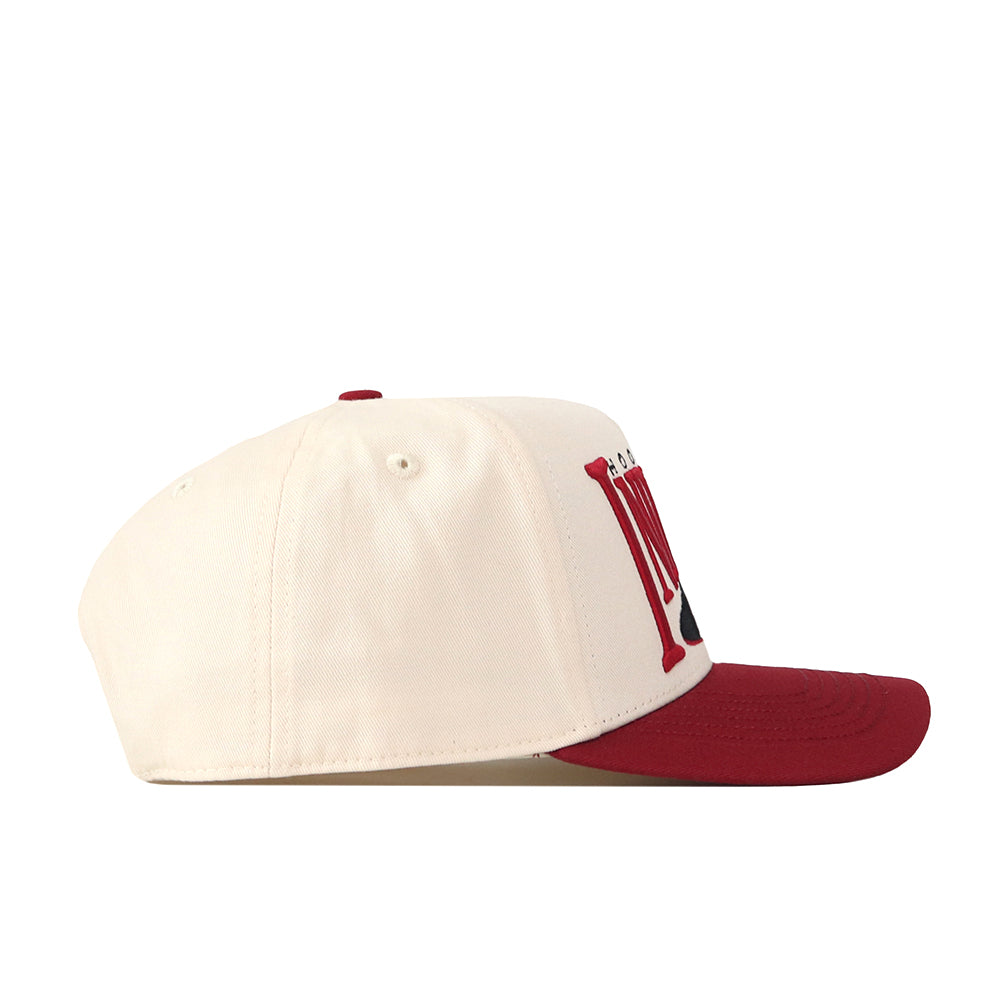 A cream-colored Indiana Hoosiers Stride Hat by No Rivals, featuring a red brim and a prominent red letter M on the front, is crafted from high-quality cotton in a structured fit and is displayed in a left side profile view against a white background.