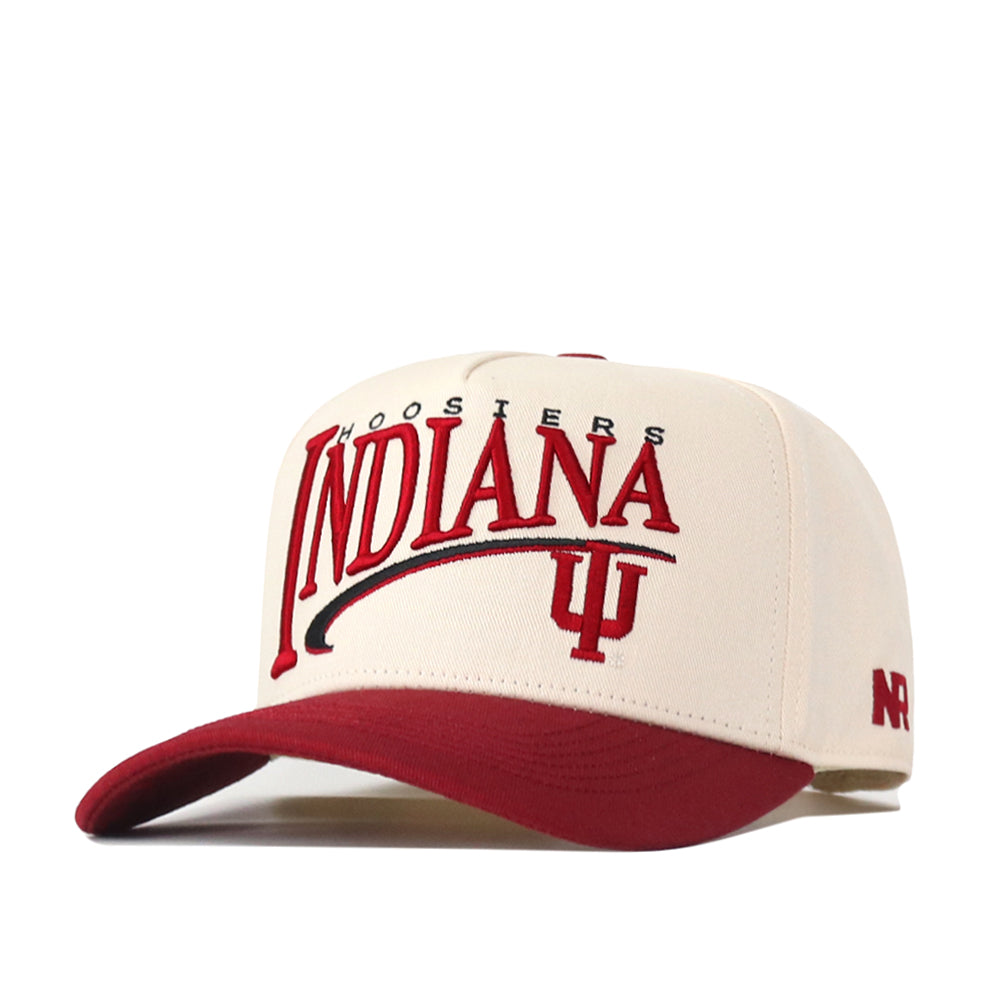 The No Rivals Indiana Hoosiers Stride Hat is a cream and red baseball cap featuring the Indiana Hoosiers and IU logo on the front. Made from high-quality cotton, this hat offers a structured fit for lasting comfort, a red brim, and ARCH embroidery on the side.