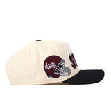A beige Mississippi State Alma Mater Hat by No Rivals features a black brim, a maroon football helmet, and “State” embroidered on the side. This officially licensed snap back cap showcases detailed embroidery, making it an eye-catching accessory for any fan.