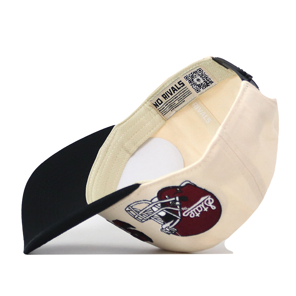 A beige and black snapback hat flipped inside out reveals a QR code tag and a maroon football helmet graphic, with the “No Rivals” text embroidered on the front panel. The officially licensed Mississippi State Alma Mater Hat combines standout style with premium details, making it perfect for fans looking for bold embroidered logos.
