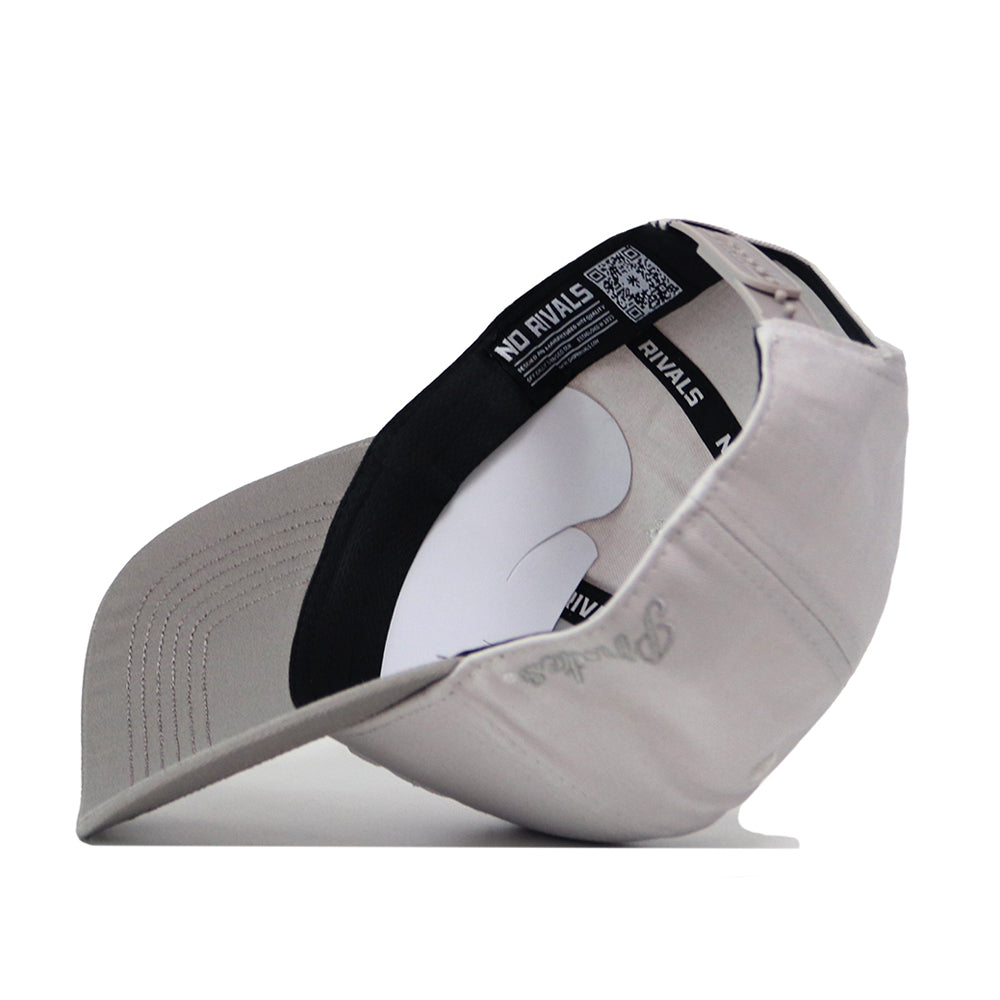 A light gray ECU Pirates Graphite Hat by No Rivals, flipped upside down to reveal the black inner band featuring the NO RIVALS text and a white cardboard insert inside the crown—crafted with a classic Snap Back design for an adjustable gameday fit.