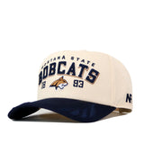 The No Rivals Montana State Rally Hat is a beige and navy snapback featuring “Montana State Bobcats 1893” and an embroidered bobcat logo on the front—an officially licensed accessory for true fans.