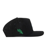 No Rivals North Texas Mean Green Football Mascot Hat in black, featuring ventilation holes, a flat brim, and an embroidered green winged logo on the side. Made from performance fabric, this snapback cap is displayed in a side profile against a white background.