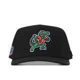 The No Rivals Florida Gators Football Mascot Hat in black features an embroidered alligator mascot wearing an orange jersey and holding a football, along with a small colorful patch on the left side. Crafted from high-quality performance fabric, this hat is finished with a snapback closure for a comfortable and customizable fit.