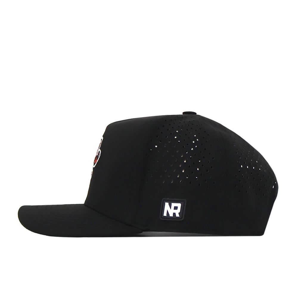 Introducing the Clemson Tigers Football Mascot Hat in black by No Rivals. This cap features small ventilation holes on the side and a flat brim, with a white rectangular embroidered NR logo patch positioned near the brim. Crafted from performance fabric, it is shown from a side profile.