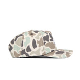 Side view of the No Rivals Montana State Huntsman Hat, showcasing a beige, olive green, and brown camo pattern in a classic 5-panel design, set against a white background.