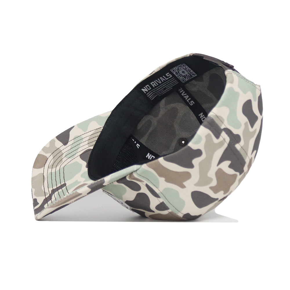 The No Rivals NDSU Huntsman Hat is a 5-panel duck camo cap in green, beige, and brown, shown side-on with the brim left and visible interior details like sweatband, inner stitching, and adjustable snap back.