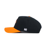The No Rivals Tennessee Baseball Home Plate Hat is a black cotton blend cap with an orange brim and white embroidered NR logo on the side. Snap back closure. Side view shown.