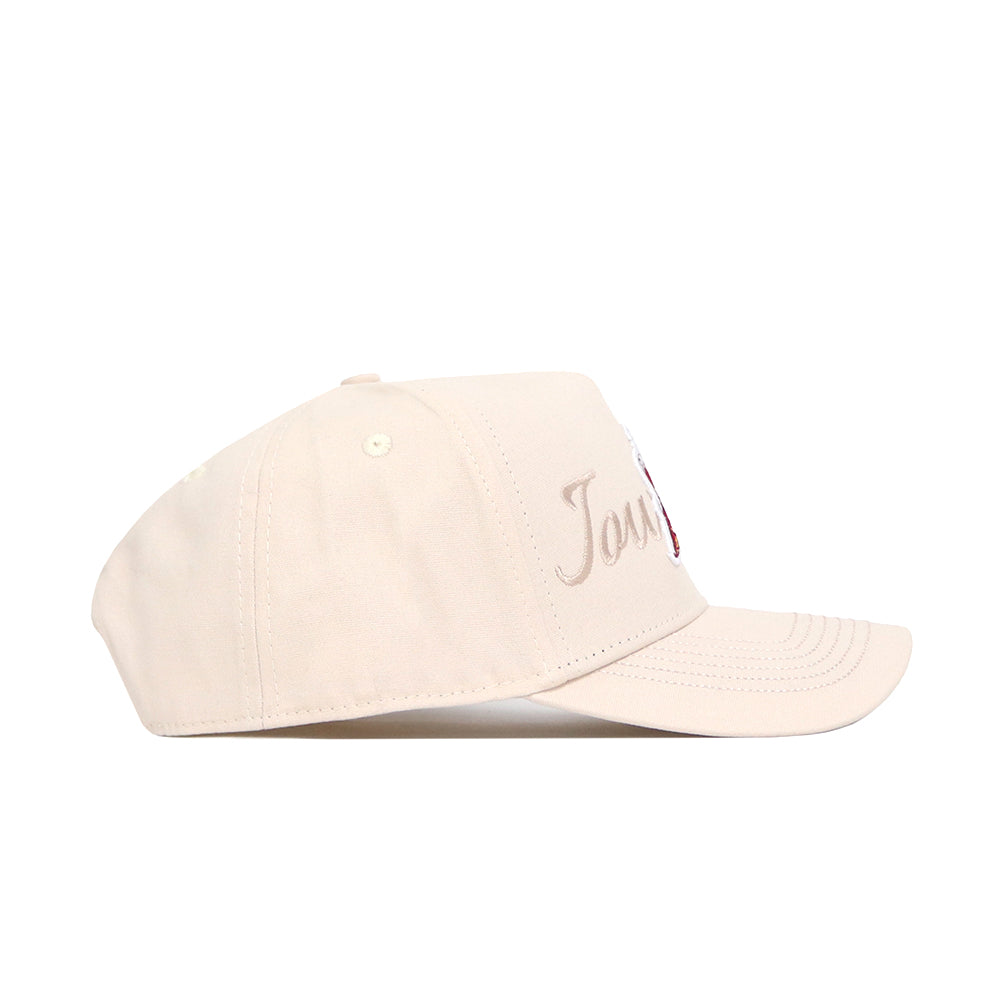 The No Rivals Iowa State Stacked Hat is a light beige snapback, shown in side profile, made from high quality cotton and featuring cursive embroidered text on the front panel.
