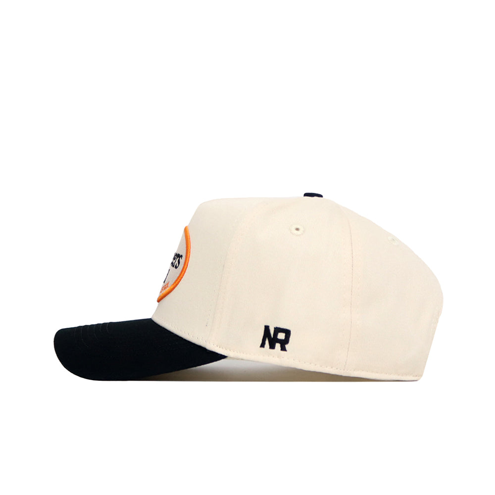The No Rivals Tennessee Baseball Slugger Hat is cream-colored with a black brim, shown in a side view. It features a small black NR embroidered logo near the back and has an adjustable snapback closure.