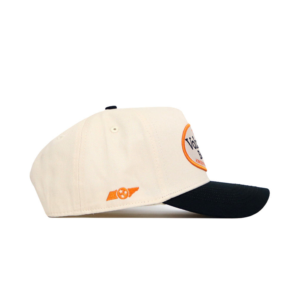 The No Rivals Tennessee Baseball Slugger Hat is a cream snapback with a black brim, orange circular logo on the front, and a small orange winged emblem on the side. Shown on its side against a white background.