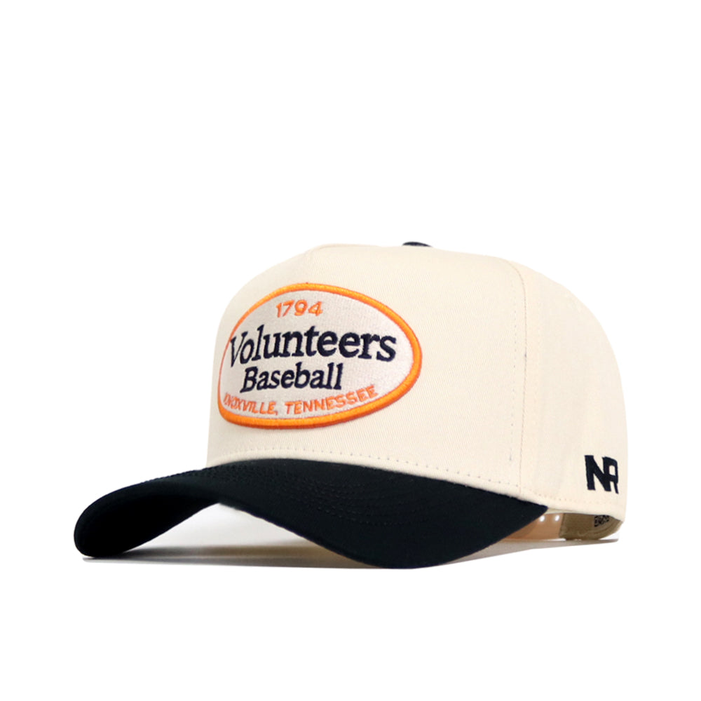 The Tennessee Baseball Slugger Hat by No Rivals is a cream and black snapback with an oval "1794 Volunteers Baseball, Knoxville, Tennessee" patch and embroidered "NR" logo on the left side. Officially licensed design.