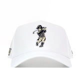 The No Rivals Vanderbilt Golf Hat - White is a snapback hat featuring embroidered graphics of a vintage cartoon golfer swinging a club, with a "V" on the golfer's hat.
