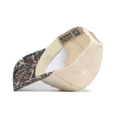 The No Rivals USF Camo Connector Hat is pictured upside down, showcasing its structured fit, white sweatband, and labels. The underside of the brim features a camo pattern and is crafted from high-quality cotton for durability.